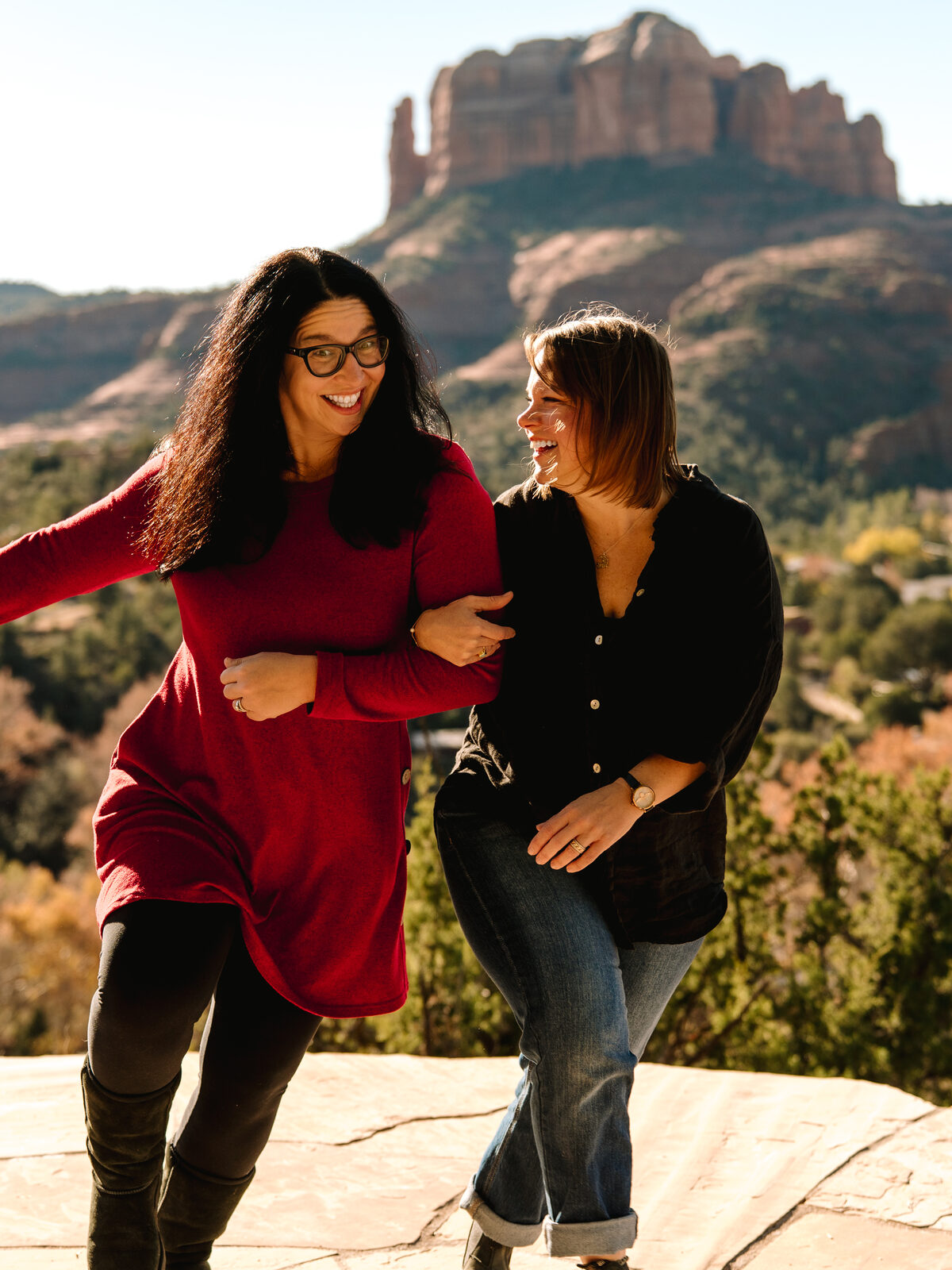 Two members laughing together at an overlook in Sedona