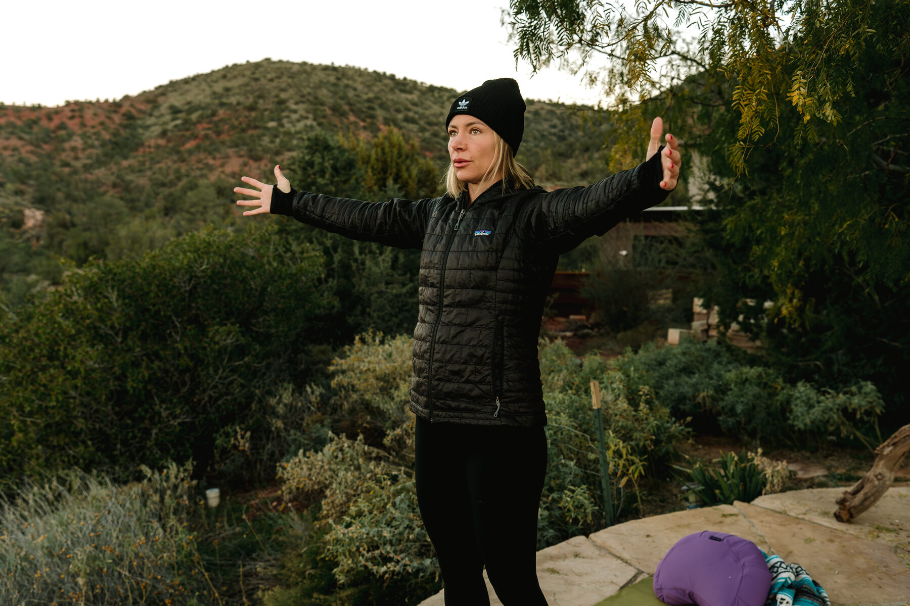 Chelsea, Soleia's founder, arms open during morning practice in Sedona